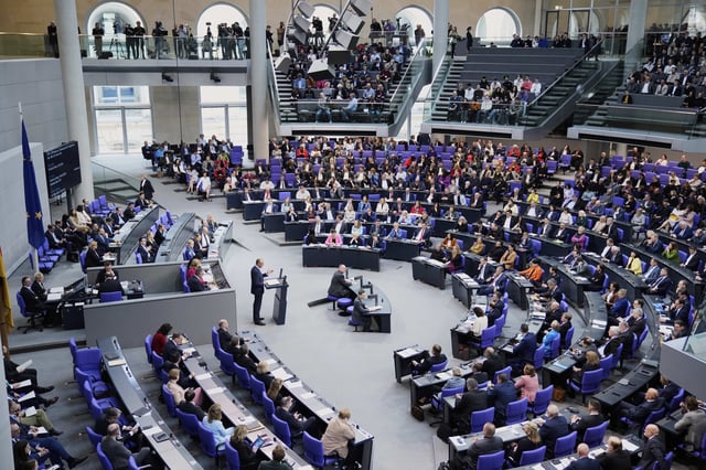 German opposition leader and Christian Democratic Union party chairman Friedrich Merz, center, delivers his speech during a meeting of the German federal parliament, Bundestag, at the Reichstag building in Berlin, Germany, Thursday, March 13, 2025. (AP Photo/Ebrahim Noroozi)