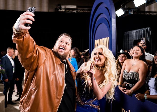 Jelly Roll and Bunnie Xo take photos with fans at the 59th Academy of Country Music Awards at The Star in Frisco, Texas.
