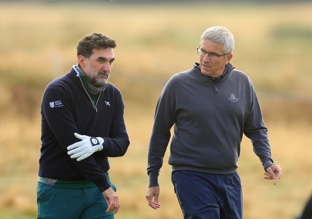 Jay Monahan of The United States the Commissioner of The PGA TOUR and His Excellency Yassir Al-Rumayyan of Saudi Arabia the Governor of The Public Investment Fund (PIF) of Saudi Arabia walk off the tee together on the 11th hole on day one of the Alfred Dunhill Links Championship 2024 on the Championship Links at Carnoustie on October 03, 2024 in St Andrews, Scotland.