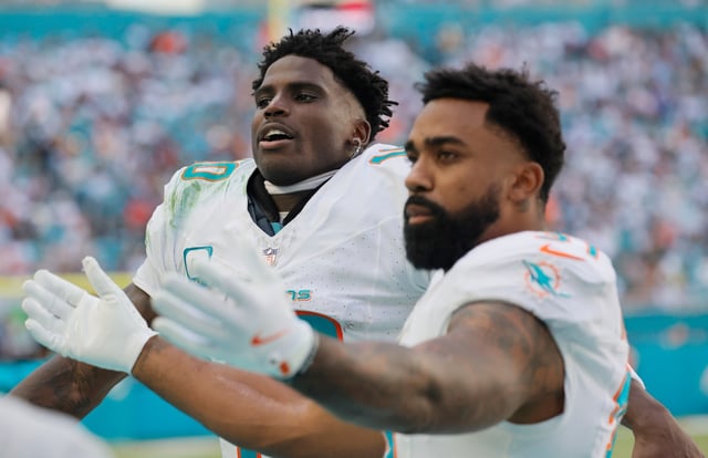 Miami Dolphins wide receiver Tyreek Hill (10) and Miami Dolphins running back Raheem Mostert (31) motivate the crowd during a game against the New England Patriots on Sunday, Nov. 24, 2024 at Hard Rock Stadium in Miami Gardens. (Joe Cavaretta/South Florida Sun Sentinel)