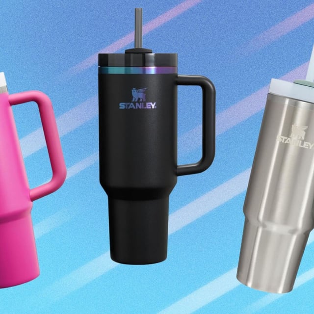 three stanley quenchers in pink, black, and stainless steel on a blue background