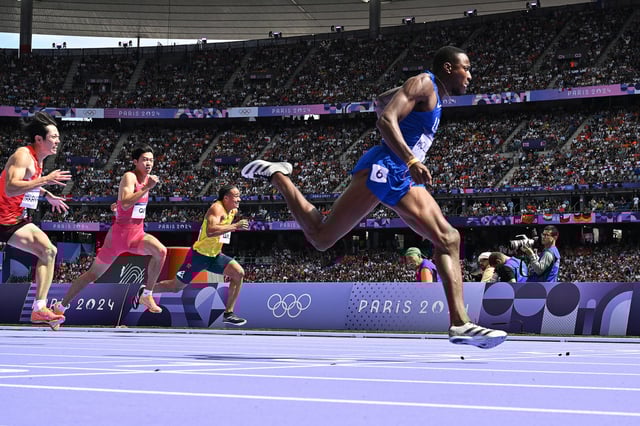 Grant Holloway crosses the finish line in the men's 110m hurdles at the Paris 2024 Olympic Games.