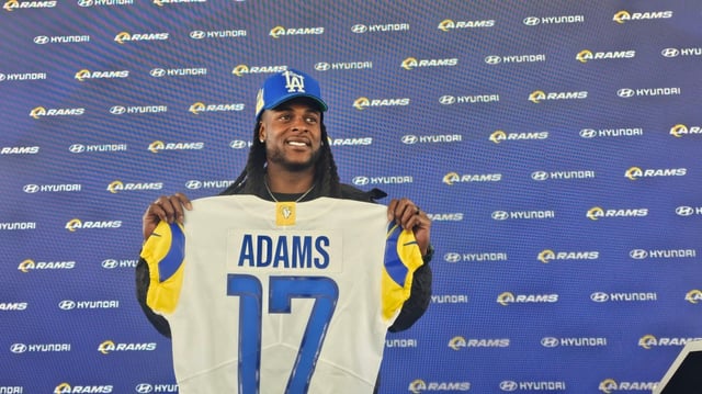 Rams wide receiver Davante Adams holds up his new jersey at Thursday’s introductory press conference at the team’s facility in Woodland Hills. (Photo by Adam Grosbard)