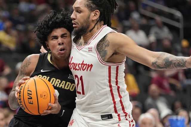 Colorado&#39;s Julian Hammond III, left, heads to the basket as Houston&#39;s Emanuel Sharp (21) defends during the first half of an NCAA college basketball game in the quarterfinal round of the Big 12 Conference tournament, Thursday, March 13, 2025, in Kansas City, Mo. (AP Photo/Charlie Riedel)