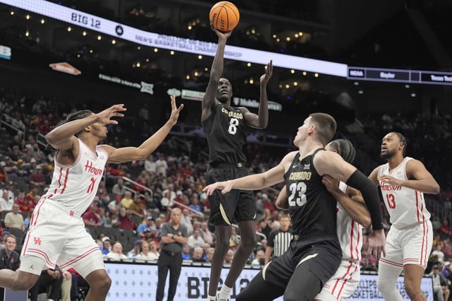 Colorado&#39;s Bangot Dak (8) shoots during the first half of an NCAA college basketball game against Houston in the quarterfinal round of the Big 12 Conference tournament, Thursday, March 13, 2025, in Kansas City, Mo. (AP Photo/Charlie Riedel)