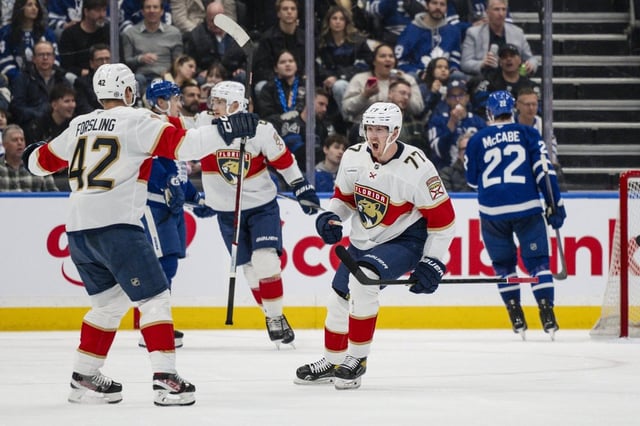 Florida Panthers' Niko Mikkola (77) celebrates with Gustav Forsling (42) after scoring during second period NHL hockey action against the Toronto Maple Leafs in Toronto, on Thursday, March 13, 2025. THE CANADIAN PRESS/Christopher Katsarov