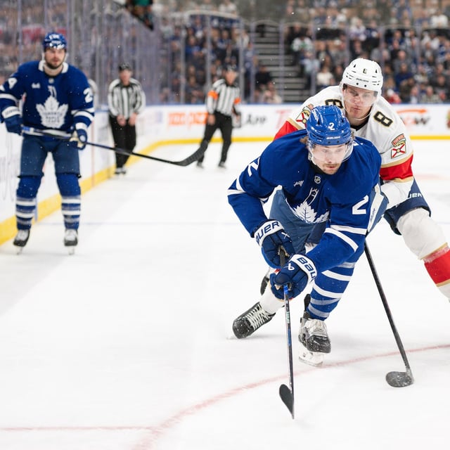 Florida Panthers' Nico Sturm (8) and Toronto Maple Leafs' Simon Benoit (2) vie for the puck during first period NHL hockey action in Toronto, on Thursday, March 13, 2025. THE CANADIAN PRESS/Christopher Katsarov