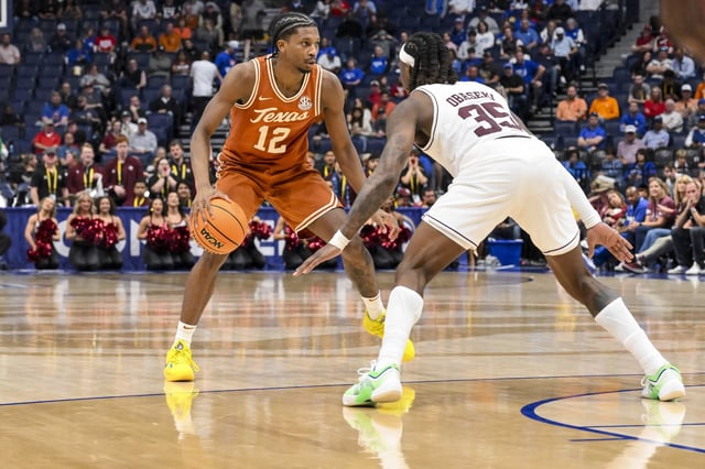 Mar 13, 2025; Nashville, TN, USA;  Texas A&M Aggies guard Manny Obaseki (35) guards Texas Longhorns guard Tramon Mark (12) during the second half at Bridgestone Arena. Mandatory Credit: Steve Roberts-Imagn Images