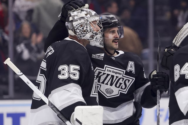 Mar 13, 2025; Los Angeles, California, USA; Los Angeles Kings goaltender Darcy Kuemper (35) and center Phillip Danault (24) celebrate after the team’s win against the Washington Capitals at Crypto.com Arena. Mandatory Credit: Ryan Sun-Imagn Images