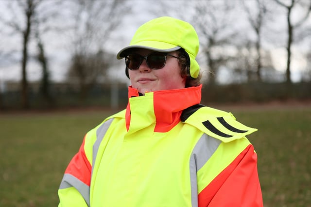 Chelsea Shubert, poses for a portrait on her uniform as a school crossing patrol, commonly known as lollipop lady, in Chatham, Britain, March 13, 2025. REUTERS/Isabel Infantes