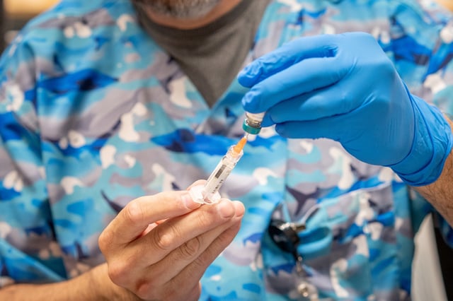 Raynard Covarrubio fills a syringe with the MMR vaccine, at a vaccine clinic put on by Lubbock Public Health Department on March 1, 2025, in Lubbock, Texas.