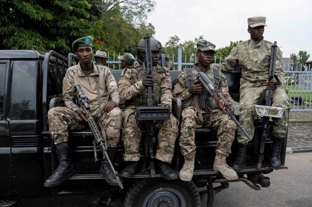 M23 rebels sit on a truck during the escort of captured FDLR members (not pictured) to Rwanda for repatriation, at the Goma-Gisenyi Grande Barrier border crossing, March 1, 2025. REUTERS/Arlette Bashizi/File Photo