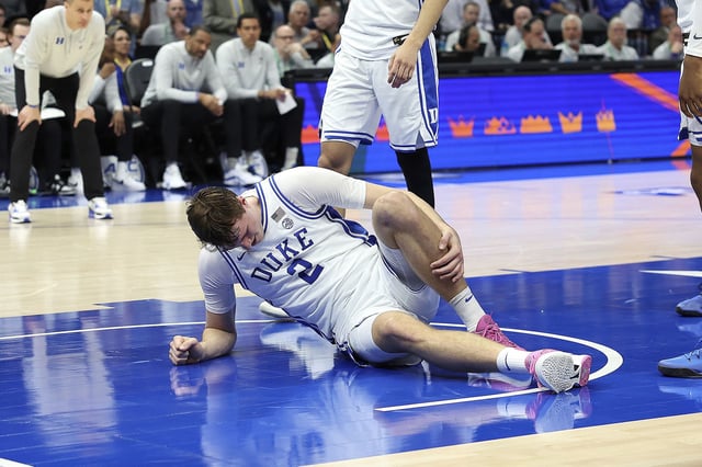 CHARLOTTE, NC - MARCH 13: Duke Blue Devils guard Cooper Flagg (2) is on the floor after an injury to his ankle late in the first half during the ACC Men's basketball tournament between the Georgia Tech Yellow Jackets and the Duke Blue Devils on March 13, 2025 at the Spectrum Center in Charlotte, N.C. (Photo by John Byrum/Icon Sportswire) (Icon Sportswire via AP Images)