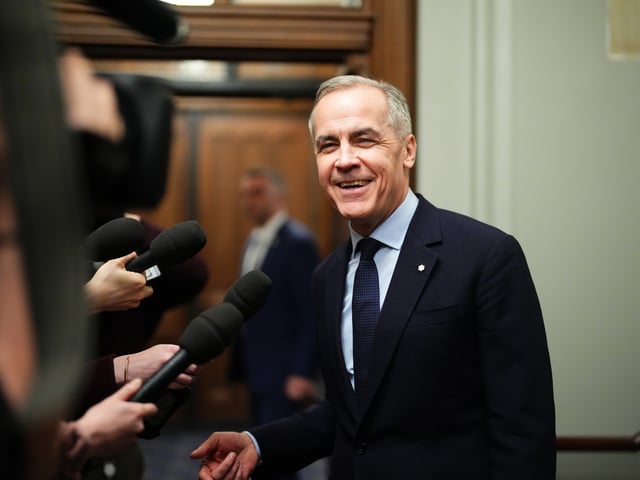 Liberal Leader Mark Carney talks to media as he leaves the prime minister's office and makes his way to a caucus meeting in Ottawa, Monday, March 10, 2025. 
