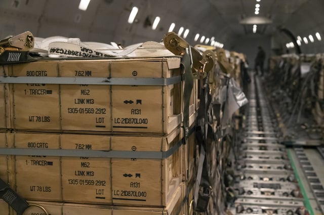 Packages of ammunition, weapons, and other equipment bound for Ukraine being loaded on a plane at the Dover Air Force Base in Delaware January 30, 2022.
