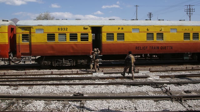 Soldiers board a relief train headed to Bolan, where a passenger train was attacked by separatist militants, at a railway station in Mach, Balochistan, Pakistan.
