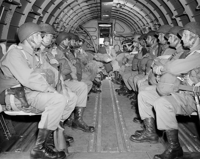 American paratroopers, heavily armed, sit inside a military plane as they soar over the English Channel en route to the Normandy French coast for the Allied D-Day invasion of the German stronghold during World War II, June 6, 1944. The Alien Enemies Act was last used during World War II. 