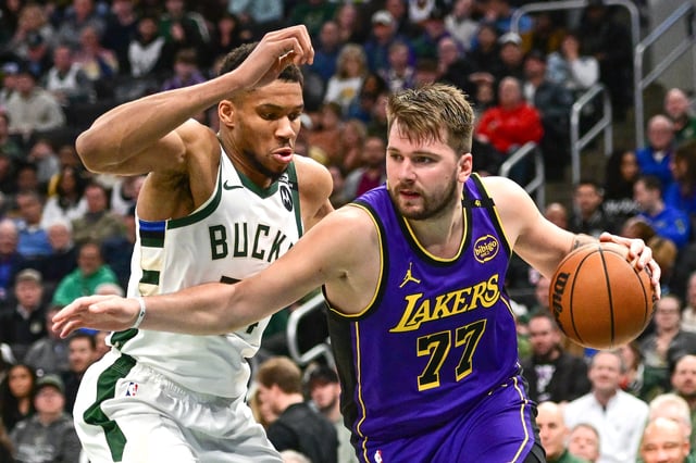 Mar 13, 2025; Milwaukee, Wisconsin, USA;  Los Angeles Lakers guard Luka Doncic (77) drives to the basket against Milwaukee Bucks forward Giannis Antetokounmpo (34) in the third quarter at Fiserv Forum. Mandatory Credit: Benny Sieu-Imagn Images/File Photo