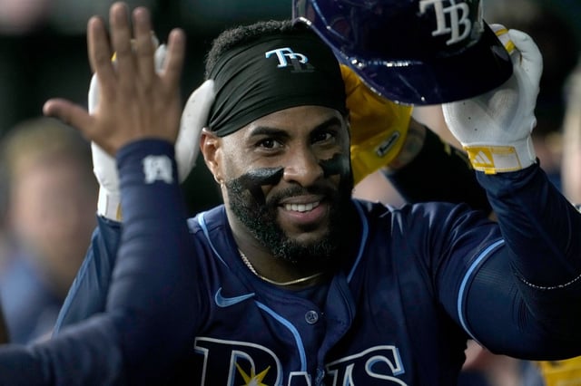 Tampa Bay&#39;s Yandy Diaz celebrates in the dugout after hitting a three-run homer in Texas in July.  (AP file photo/Tony Gutierrez)