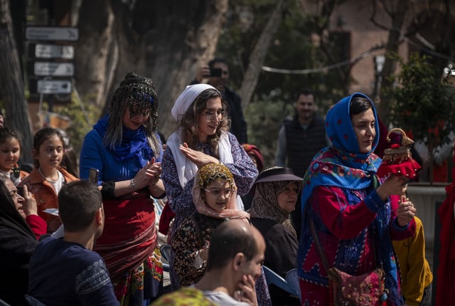 An Iranian woman wears traditional dresses and performs with a wooden goat doll, a symbol of the arrival of spring, in a ceremony to welcome the Iranian New Year outside the Cinema Museum in northern Tehran, Iran, on March 14, 2025. Nowruz, meaning ''New Day,'' the Iranian New Year, marks the arrival of spring on the vernal equinox. It symbolizes renewal and features traditions like spring cleaning and the Haft-Sin table. Celebrated across many countries, it is recognized by UNESCO as cultural heritage. (Photo by Morteza Nikoubazl/NurPhoto via AP)