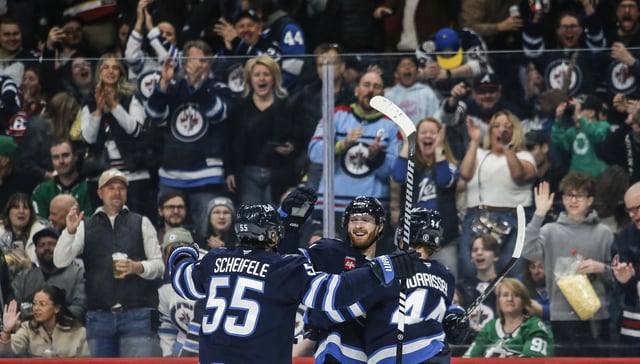 Winnipeg Jets' Mark Scheifele (55), Kyle Connor (81), and Josh Morrissey (44) celebrate Connor's goal against the Dallas Stars during second period NHL action in Winnipeg on Friday, March 14, 2025. THE CANADIAN PRESS/John Woods