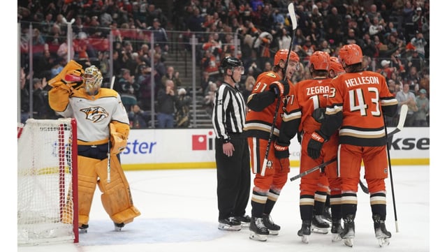 Ducks players celebrate a tiebreaking goal by Alex Killorn in front of Nashville Predators goaltender Juuse Saros during the third period on Friday night at the Honda Center. The Ducks held on to win, 2-1. (AP Photo/Jae C. Hong)