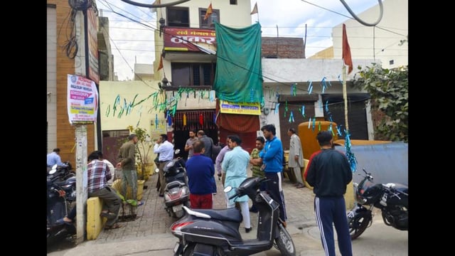 People gather outside Thakur Dwara temple on Shershah Suri road near Khandwala in Amritsar after the blast on Saturday. (Sameer Sehgal/HT)