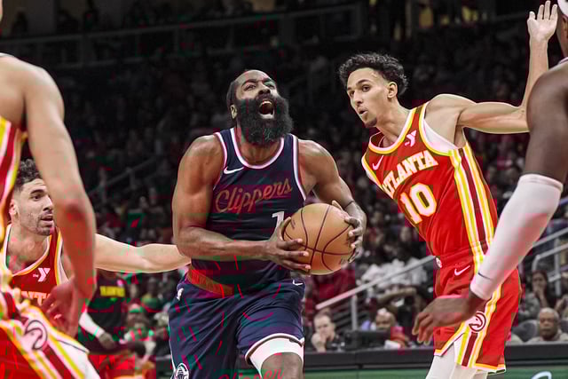 Mar 14, 2025; Atlanta, Georgia, USA; LA Clippers guard James Harden (1) drives the ball past Atlanta Hawks forwards Georges Niang (20) and Zaccharie Risacher (10) during the second half at State Farm Arena. Mandatory Credit: Dale Zanine-Imagn Images