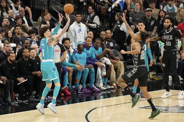 Mar 14, 2025; San Antonio, Texas, USA; Charlotte Hornets guard LaMelo Ball (1) shoots over San Antonio Spurs guard Devin Vassell (24) during the second half at Frost Bank Center. Mandatory Credit: Scott Wachter-Imagn Images