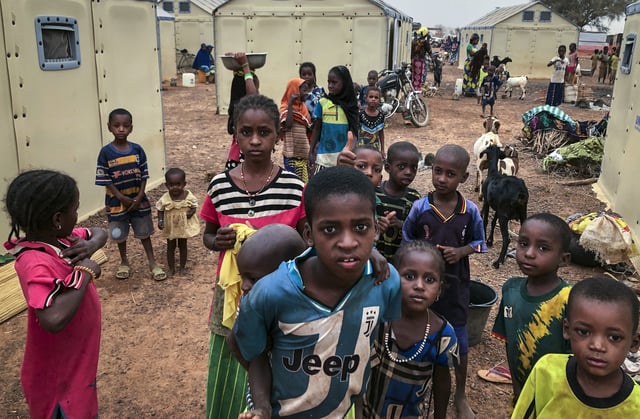 FILE - Children of around 6,000 ethnic Fulanis who have been displaced by attacks, gather in a makeshift camp for the displaced in Youba in Yatenga province in Burkina Faso, Monday, April 20, 2020. (AP Photo/Sam Mednick, File)
