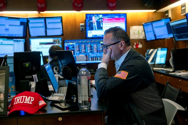 Traders work on the floor of the New York Stock Exchange on Tuesday as the Dow was off as nearly  nearly 500 points in morning trading.