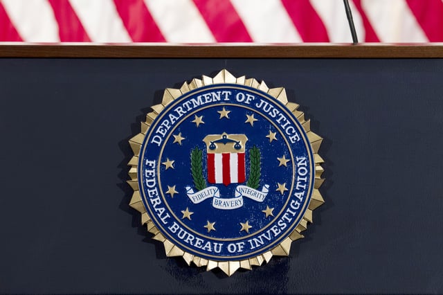FILE - This June 14, 2018 file photo shows an FBI seal on a podium before a news conference at the agency's headquarters in Washington. (AP Photo/Jose Luis Magana, File)