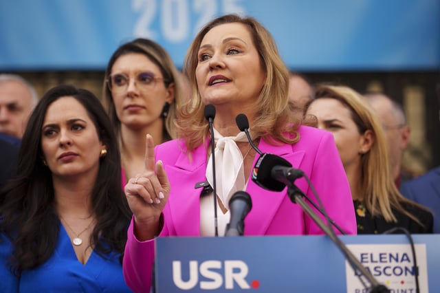 Elena Lasconi, presidential candidate for the Save Romania Union (USR) party, gestures outside the electoral authority after registering her bid to enter the May presidential election rerun in Bucharest, Romania, Thursday, March 13, 2025. (AP Photo/Vadim Ghirda)