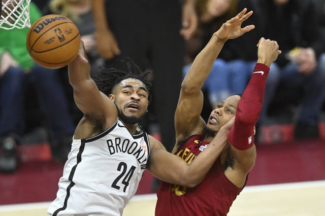 Mar 11, 2025; Cleveland, Ohio, USA; Brooklyn Nets guard Cam Thomas (24) and Cleveland Cavaliers forward Isaac Okoro (35) reach for the ball in the fourth quarter at Rocket Arena. David Richard-Imagn Images/File Photo