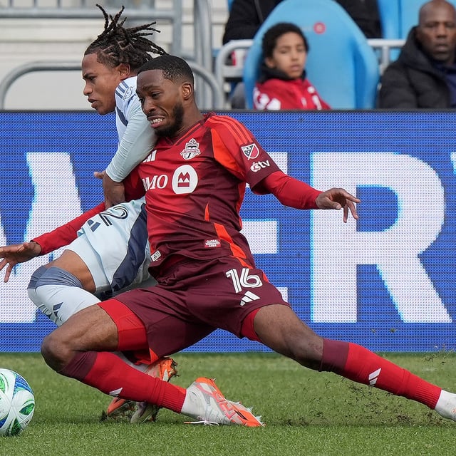 Toronto FC forward Tyrese Spicer (16) and Chicago Fire defender Leonardo Barroso (2) go down together vying for the ball during second half MLS action in Toronto, Saturday, March 15, 2025. THE CANADIAN PRESS/Frank Gunn