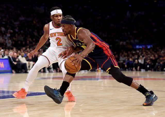 Jimmy Butler III #10 of the Golden State Warriors looks to get past Miles McBride #2 of the New York Knicks in the first half at Madison Square Garden on March 04, 2025 in New York City.