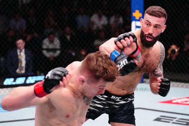 Roman Dolidze of Georgia punches Marvin Vettori of Italy in a middleweight fight during the UFC Fight Night event at UFC APEX on March 15, 2025 in Las Vegas, Nevada.
