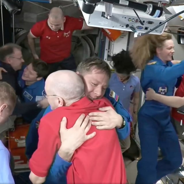 This image made from video by NASA shows astronauts Don Pettit, bottom center, hugging Kirill Peskov as astronauts greet each other after the SpaceX capsule docked with the International Space Station, Sunday, March 16, 2025. (NASA via AP)