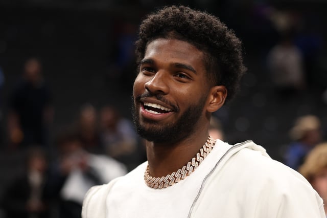 American college football player Shedeur Sanders looks on after the game between the Dallas Mavericks and the Denver Nuggets at American Airlines Center on January 14, 2025 in Dallas, Texas.