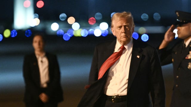 US President Donald Trump steps off Air Force One as he arrives at Palm Beach International Airport in West Palm Beach, Florida, on March 14, 2025. Trump is spending the weekend at his Mar-a-Lago resort. (Photo by BRENDAN SMIALOWSKI/AFP via Getty Images)