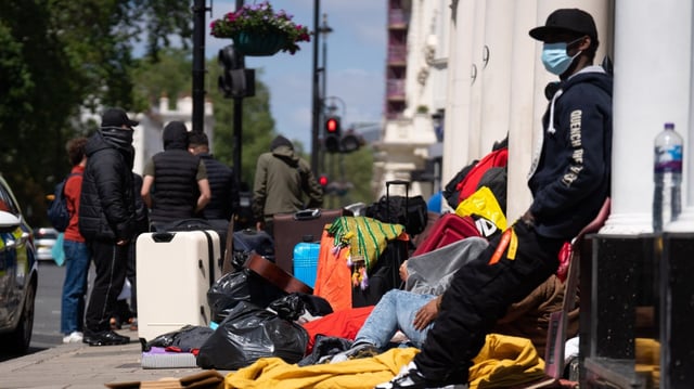 Asylum seekers outside the Comfort Inn in Pimlico, London, after being placed there by the Home Office in 2023