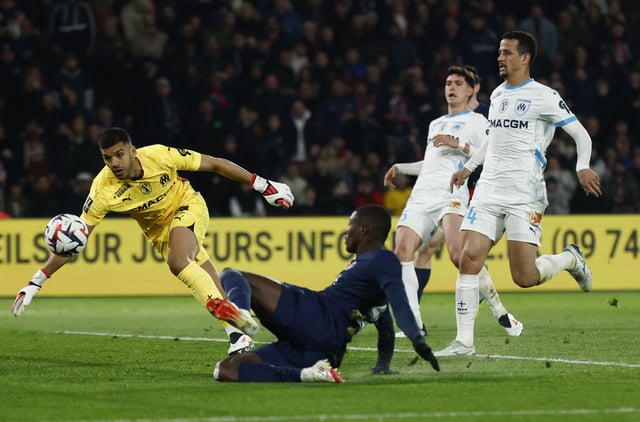 Soccer Football - Ligue 1 - Paris St Germain v Olympique de Marseille - Parc des Princes, Paris, France - March 16, 2025 Paris St Germain's Nuno Mendes scores their second goal past Olympique de Marseille's Geronimo Rulli REUTERS/Stephanie Lecocq