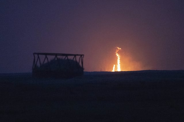A wildfire burns through a field Friday, March 14, 2025, south of Langston, Okla. (AP Photo/Alonzo Adams)