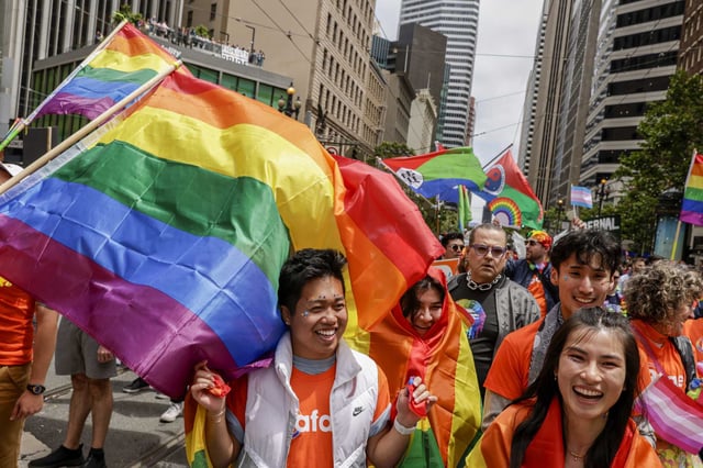 From left, Don Ly, Amy Newman and Chris Kim and Aurora Sin participate in the 2023 Pride Parade in San Francisco. 