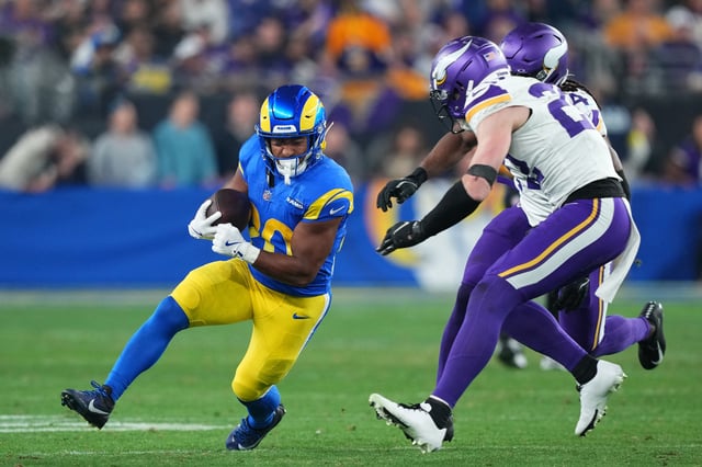 Jan 13, 2025; Glendale, AZ, USA; Los Angeles Rams running back Ronnie Rivers (20) rushes the ball against Minnesota Vikings safety Josh Metellus (44) during the second half in an NFC wild card game at State Farm Stadium. Joe Camporeale-Imagn Images/File Photo