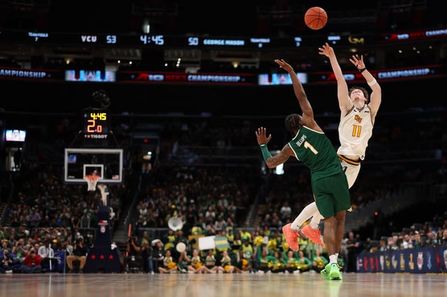 Mar 16, 2025; Washington, D.C., USA; VCU Rams guard Max Shulga (11) is fouled by George Mason Patriots guard Jared Billups (1) while shooting a three point field goal in the second half at Capital One Arena. Geoff Burke-Imagn Images