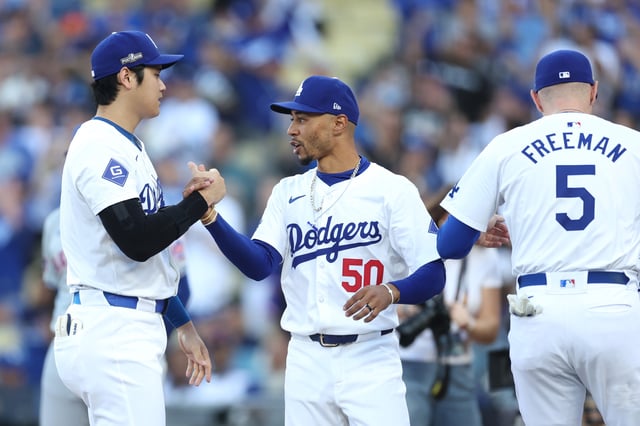 LOS ANGELES, CALIFORNIA - OCTOBER 13: Shohei Ohtani #17 and Mookie Betts #50 of the Los Angeles Dodgers meet before Game One of the Championship Series against the New York Mets at Dodger Stadium on October 13, 2024 in Los Angeles, California.