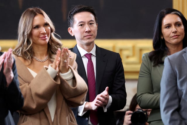 TikTok CEO Shou Zi Chew and Director of National Intelligence (DNI) Tulsi Gabbard applaud on the day of the Presidential Inauguration of Donald Trump at the Rotunda of the U.S. Capitol in Washington, U.S., January 20, 2025. REUTERS/Kevin Lamarque/Pool/File Photo