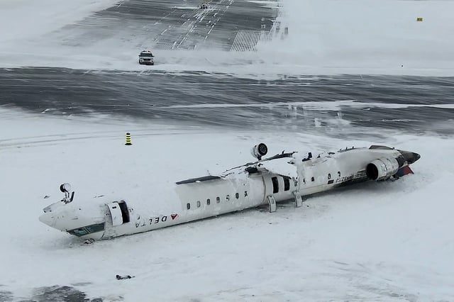  A drone view of the wreckage of a Delta Air Lines operated CRJ-900 aircraft lies crashed on the runway at Toronto Pearson International Airport in Mississauga, Ontario, Canada February 18, 2025 in a still image from video. TSB/Handout via REUTERS THIS IMAGE HAS BEEN SUPPLIED BY A THIRD PARTY