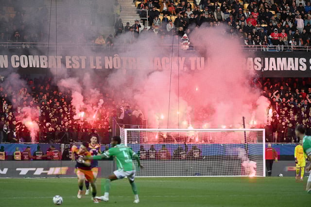 TOPSHOT - Montpellier's supporters light flares during the French L1 football match between Montpellier Herault SC and AS Saint-Etienne at Stade de la Mosson in Montpellier, southern France, on March 16, 2025. (Photo by Sylvain THOMAS / AFP) (Photo by SYLVAIN THOMAS/AFP via Getty Images)          